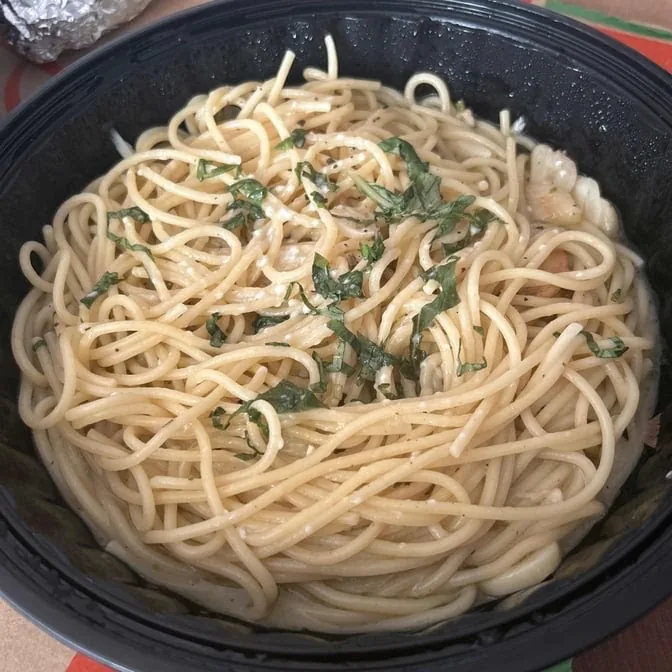 A bowl of spaghetti with herbs